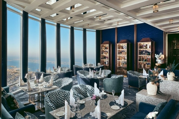 Fine dining setup at At.mosphere Restaurant on Level 122 of the Burj Khalifa, with floor-to-ceiling windows offering sweeping views of Dubai.